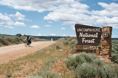 Penny riding across the highlands of Uncompahgre National Forest under scudding clouds.