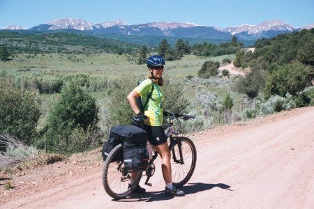 Penny up on the plateau, after the big morning climb, with the La Sal mountains ahead in the distance.